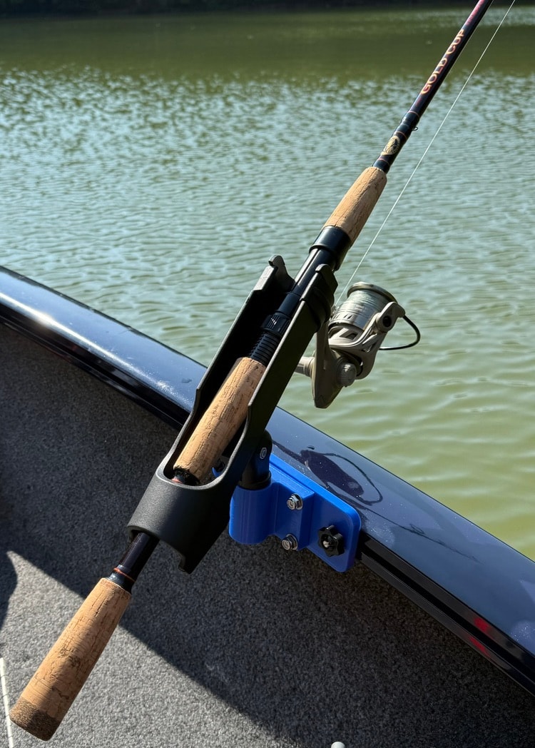 Fishing rod secured in rail-mount rod holder on boat