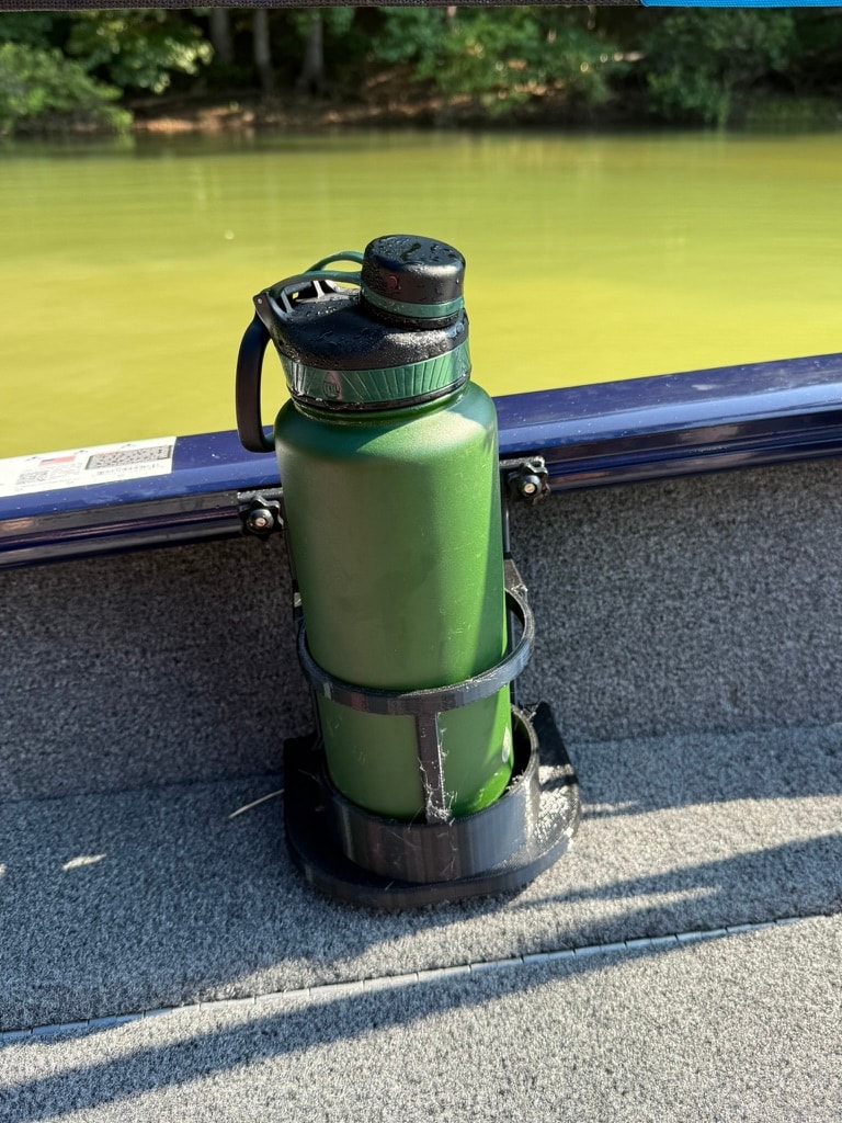 Black rail-mount drink holder securing a green water bottle on boat