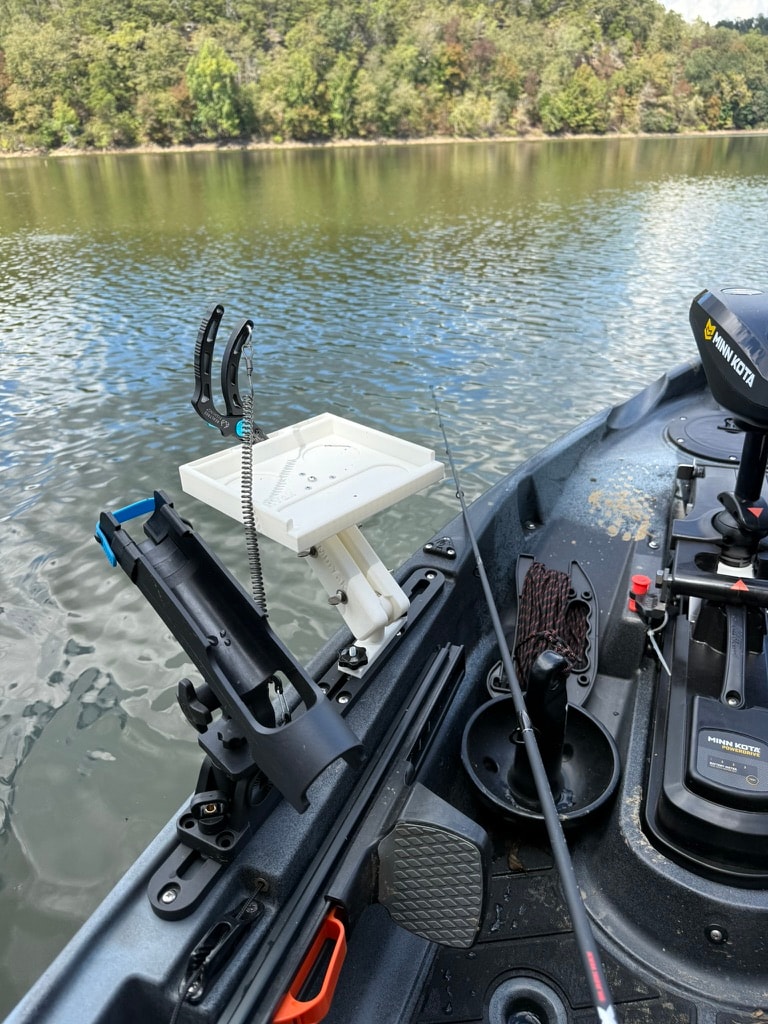 Swivel utility tray showing rotating top on kayak rail